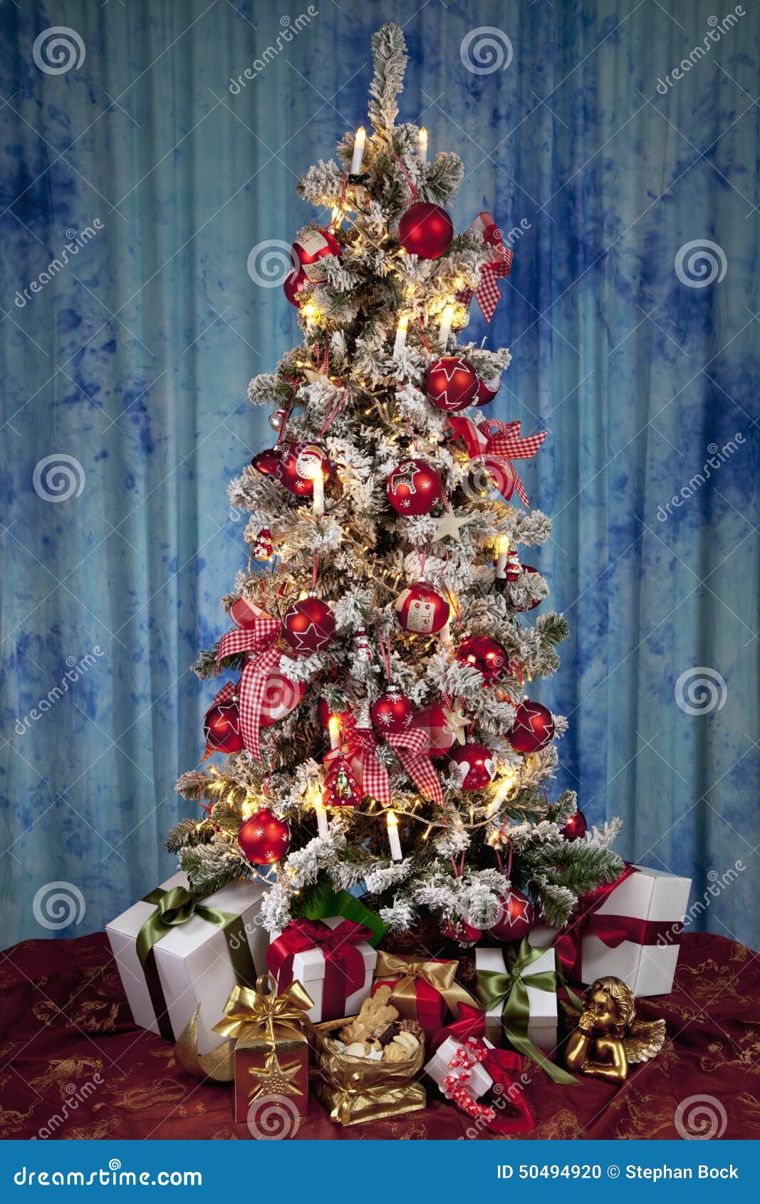 Decorated Christmas Tree with Electric Candles and Presents Stock Photo
