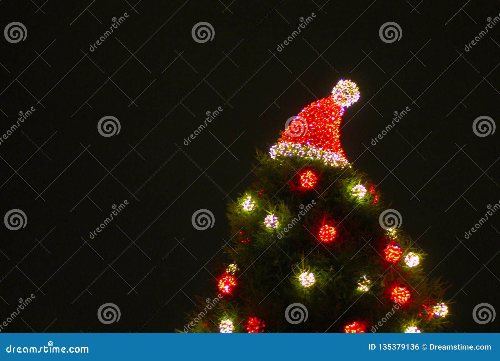 Decorated Christmas Tree Outdoor with Lights and Santa Hat Stock Photo ...