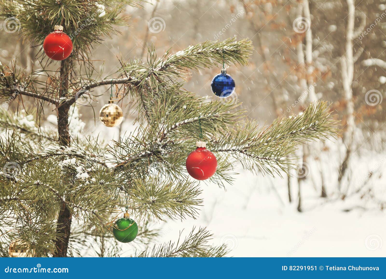 Decorated Christmas Tree in a Snowy Pine Forest with Retro Effect Stock