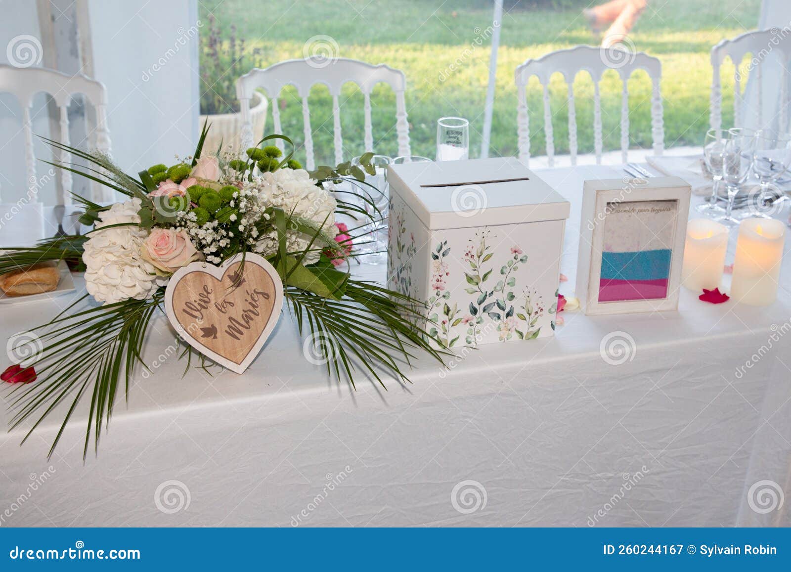 decorated wedding table with text french urn vive les maries means long live the bride and groom and sand box marked together