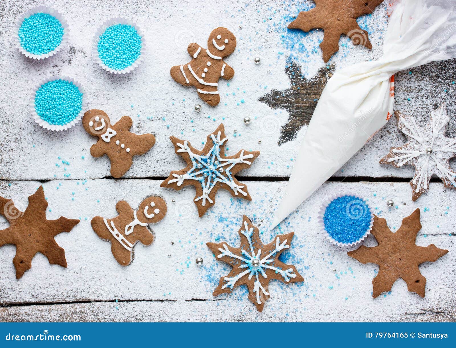 decorating gingerbread man and snowflake christmas cookie background, christmas treats for kids cooking process