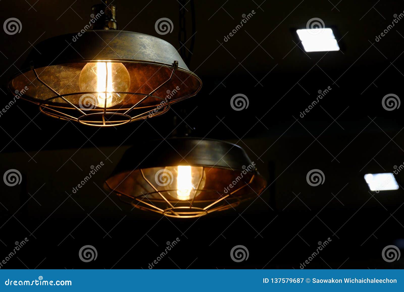 A Modern Light Lamp Hanging From The Room Ceiling With Dark