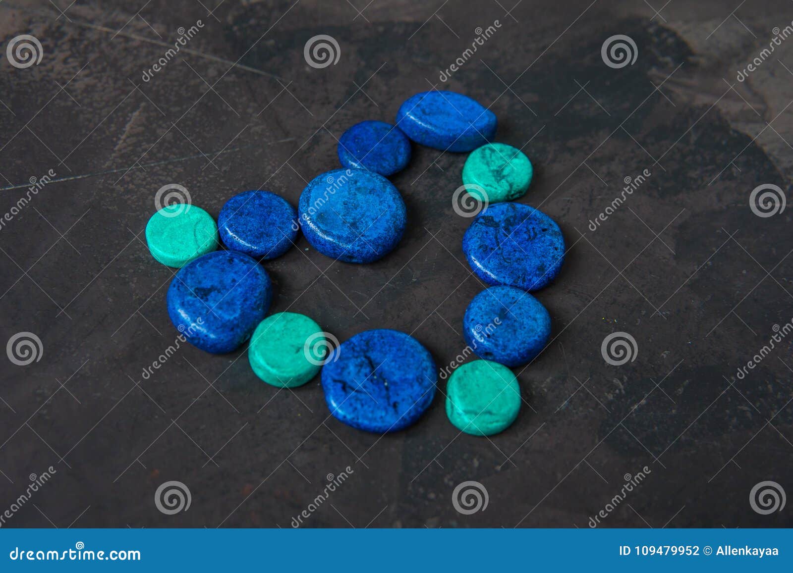 Decorative Blue Stones Shaped Heart on a Dark Background Stock Photo