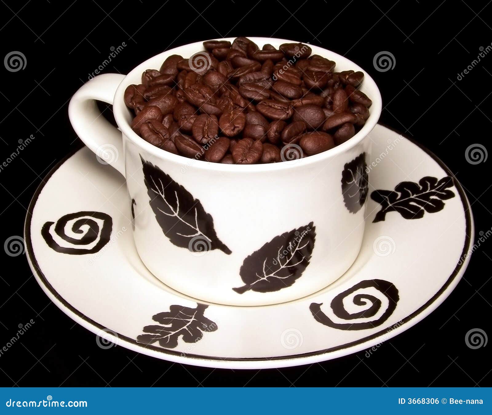 Decorative Coffee Cup On Pile Of Coffee Beans Stock Image