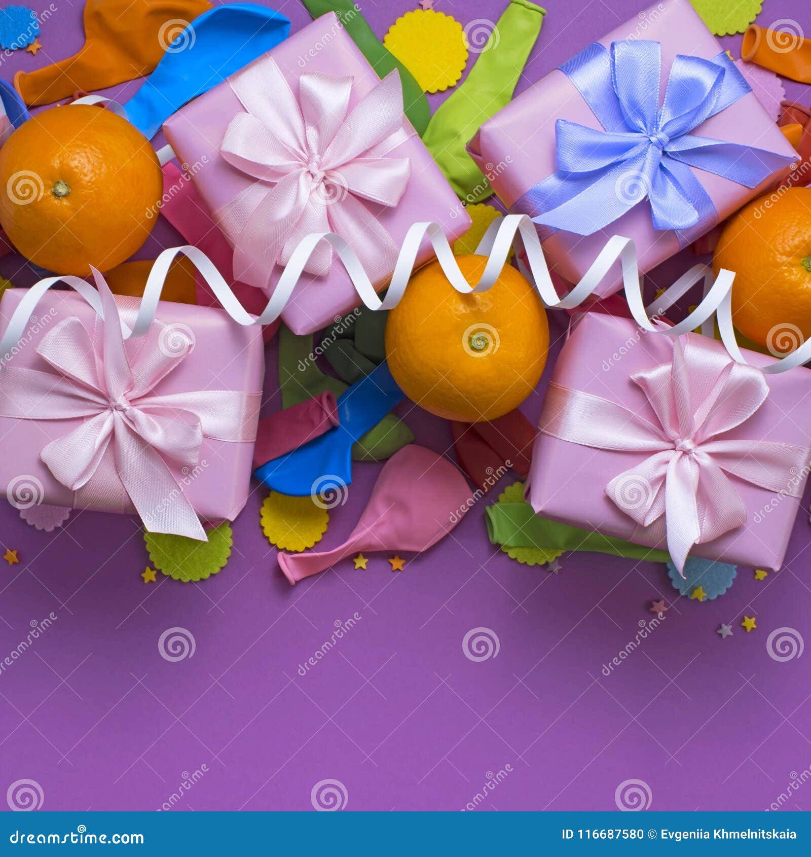 decorative composition four boxes with gifts satin ribbon bow oranges confetti serpentine birthday party.