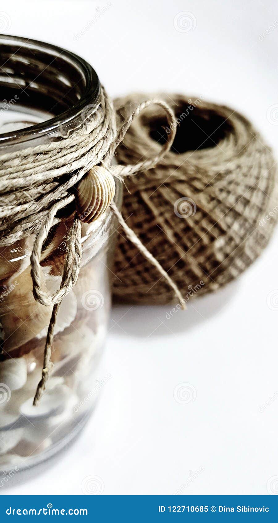 Decorative Glass Jar With Seashells And Hemp String Stock Image