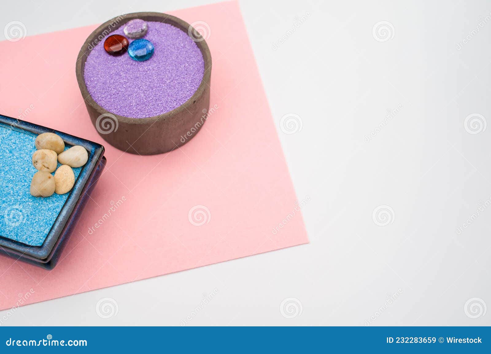 Decorative Vases with Colored Sand and Pebbles on a White Background