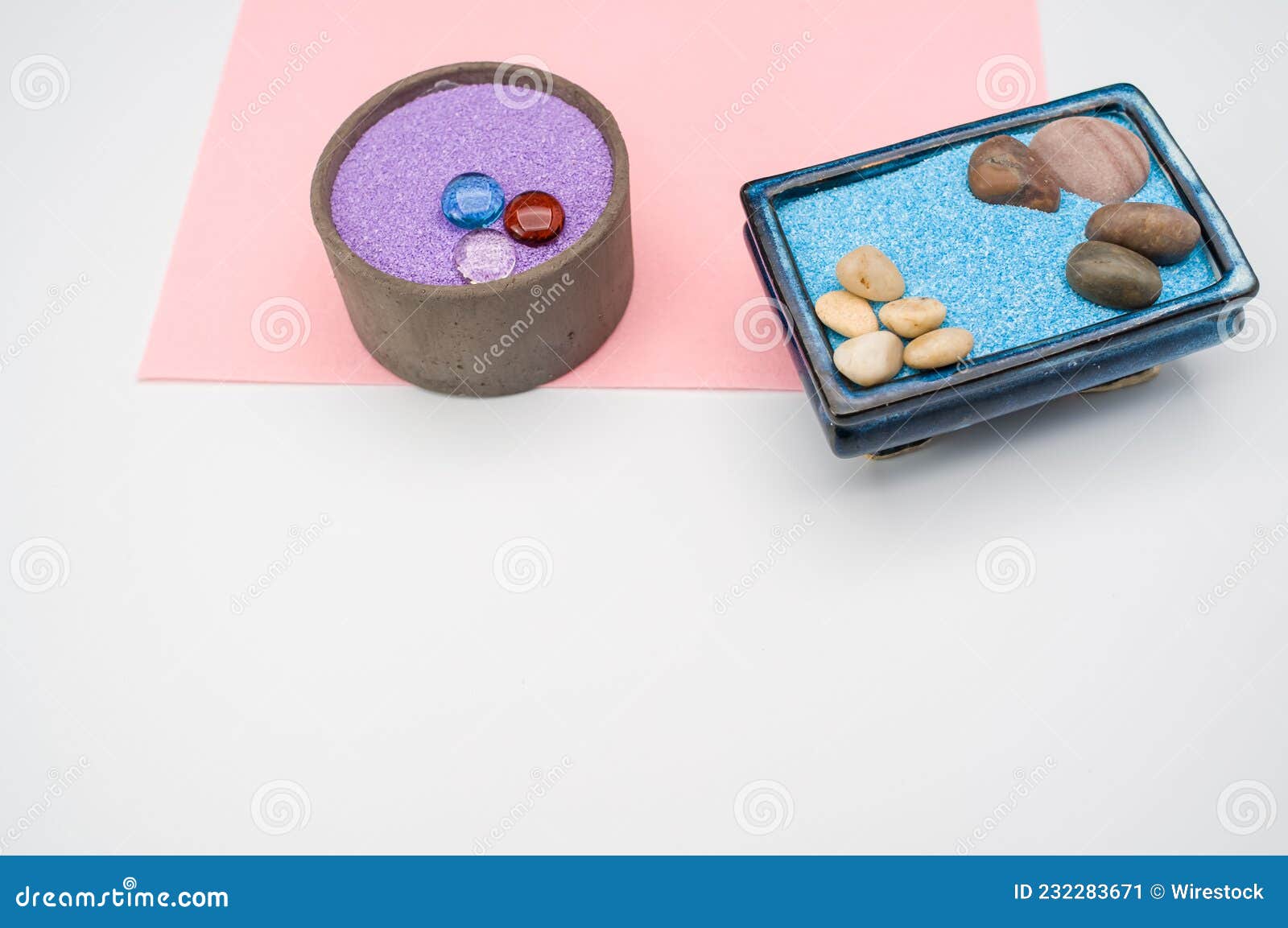 Decorative Vases with Colored Sand and Pebbles on a White Background