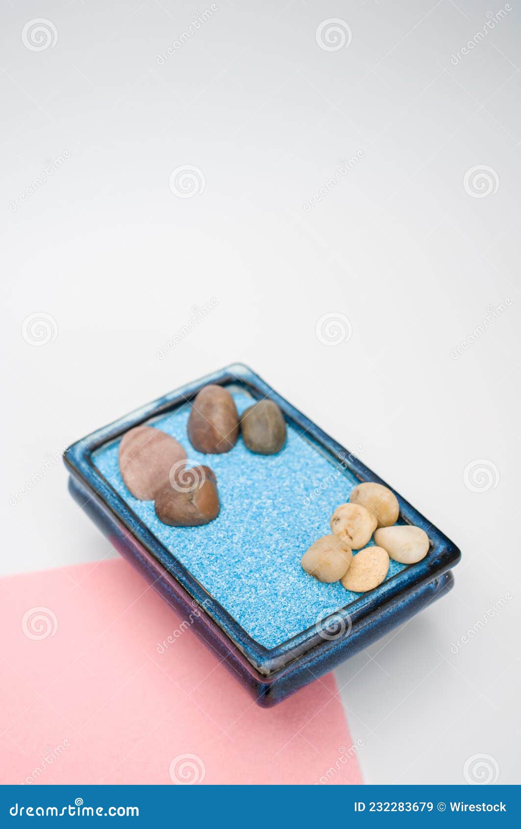 Decorative Vases with Colored Sand and Pebbles on a White Background