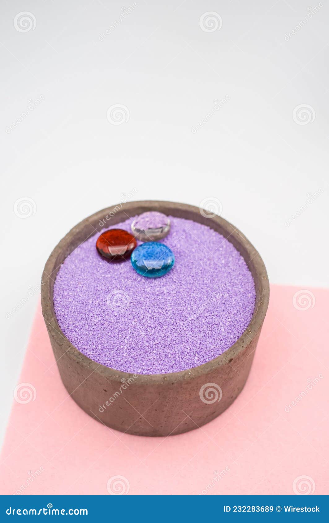 Decorative Vases with Colored Sand and Pebbles on a White Background
