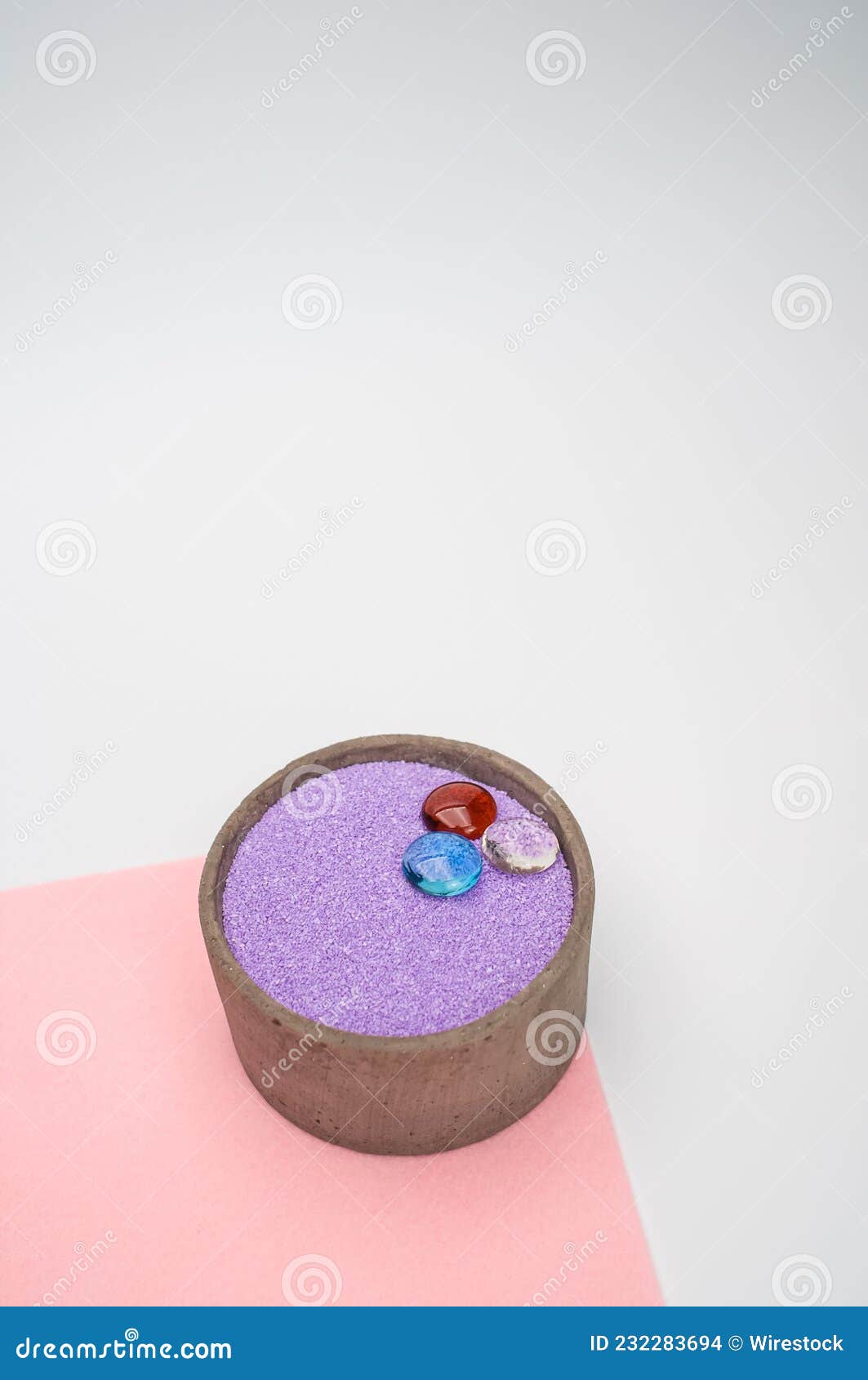 Decorative Vases with Colored Sand and Pebbles on a White Background