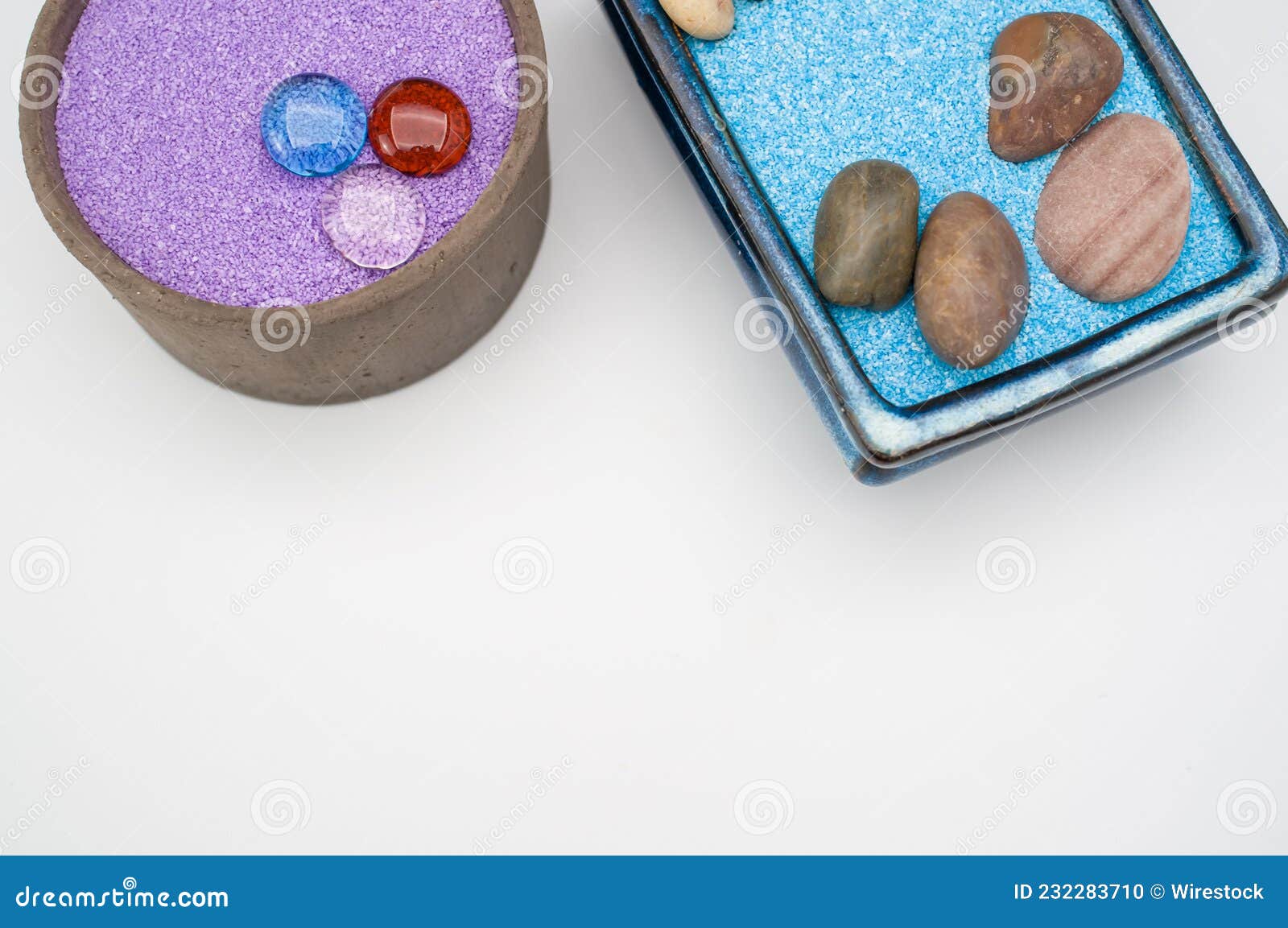 Decorative Vases with Colored Sand and Pebbles on a White Background
