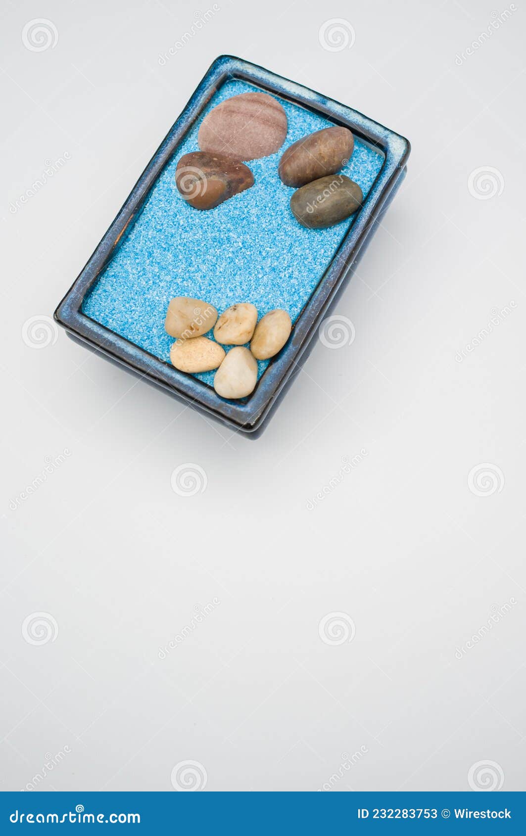 Decorative Vases with Colored Sand and Pebbles on a White Background