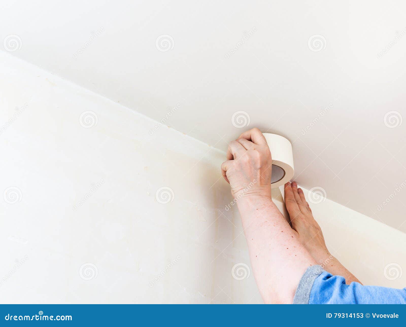 Decorator Fixes Tape On Wall Before Painting Stock Image