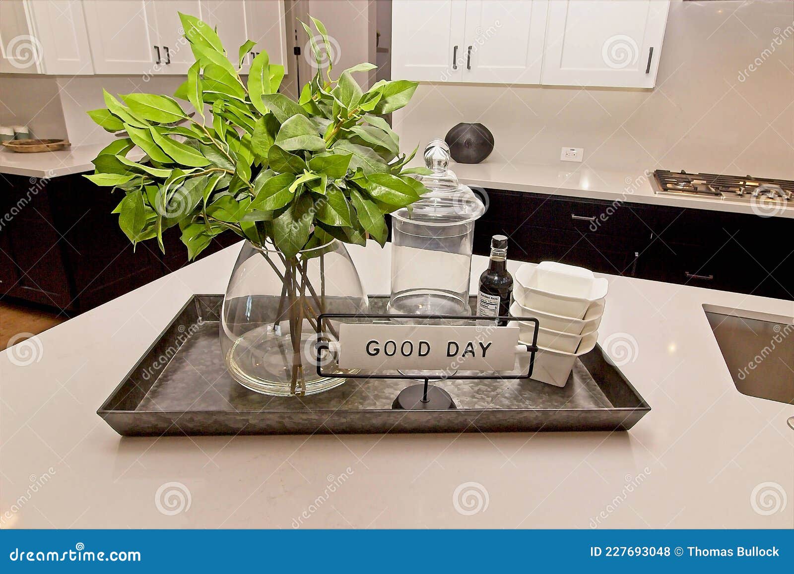 Kitchen Island with Metal Tray of Flowers, Containers and Bowls