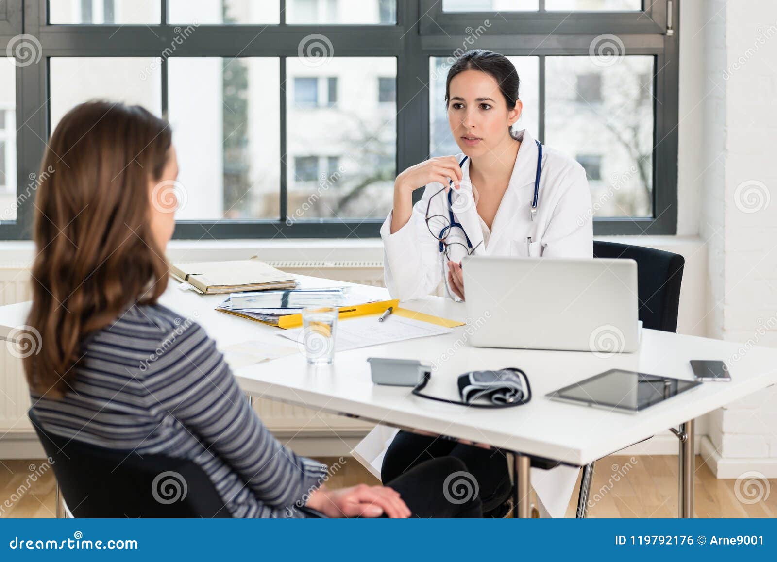 dedicated doctor listening to her patient during a private consultation