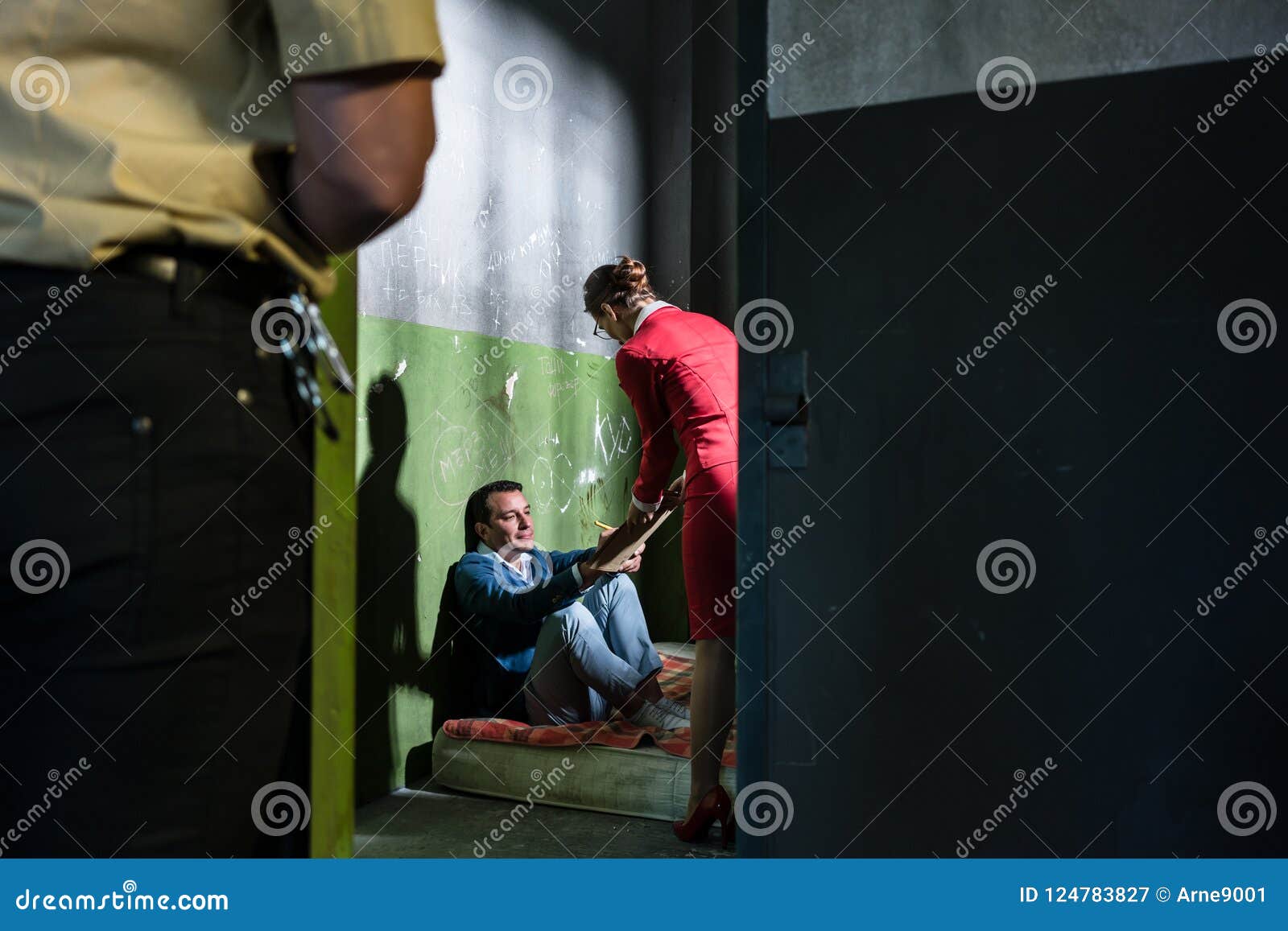 dedicated female attorney visiting a young inmate in an obsolete prison cell