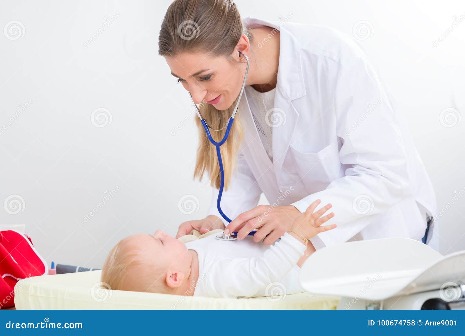 dedicated pediatrician using the stethoscope during the check-up
