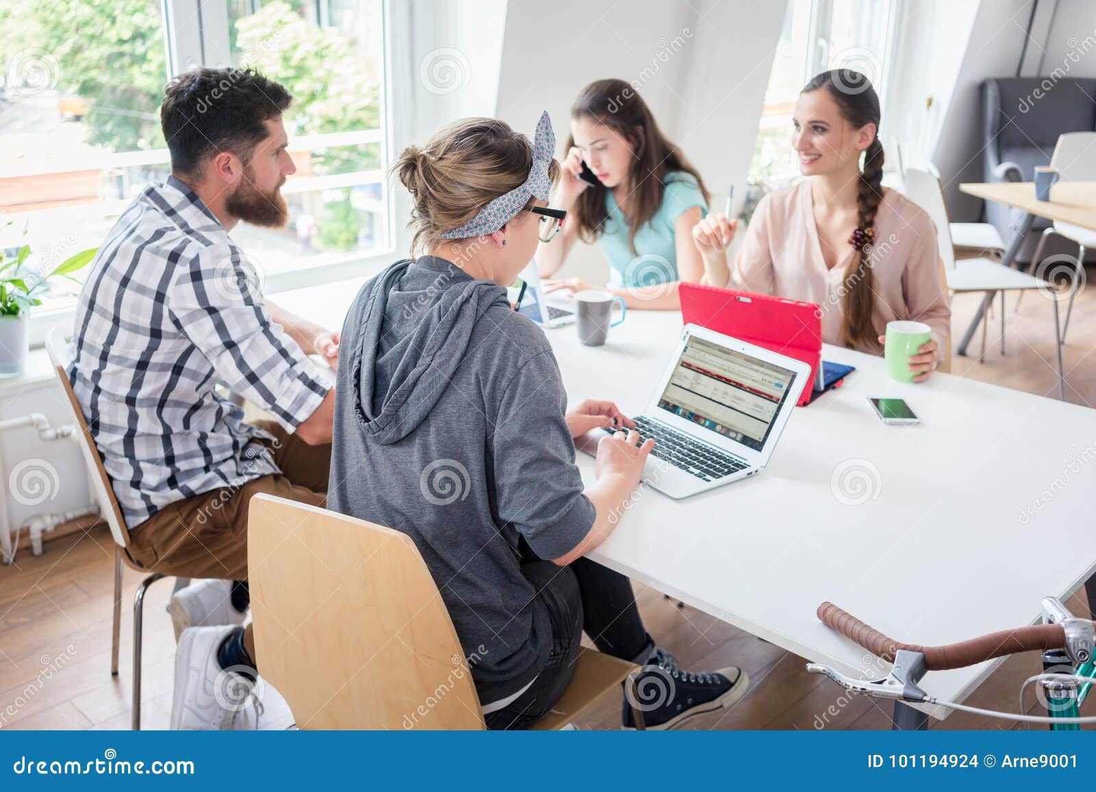 dedicated young woman editing a document in a modern office spac