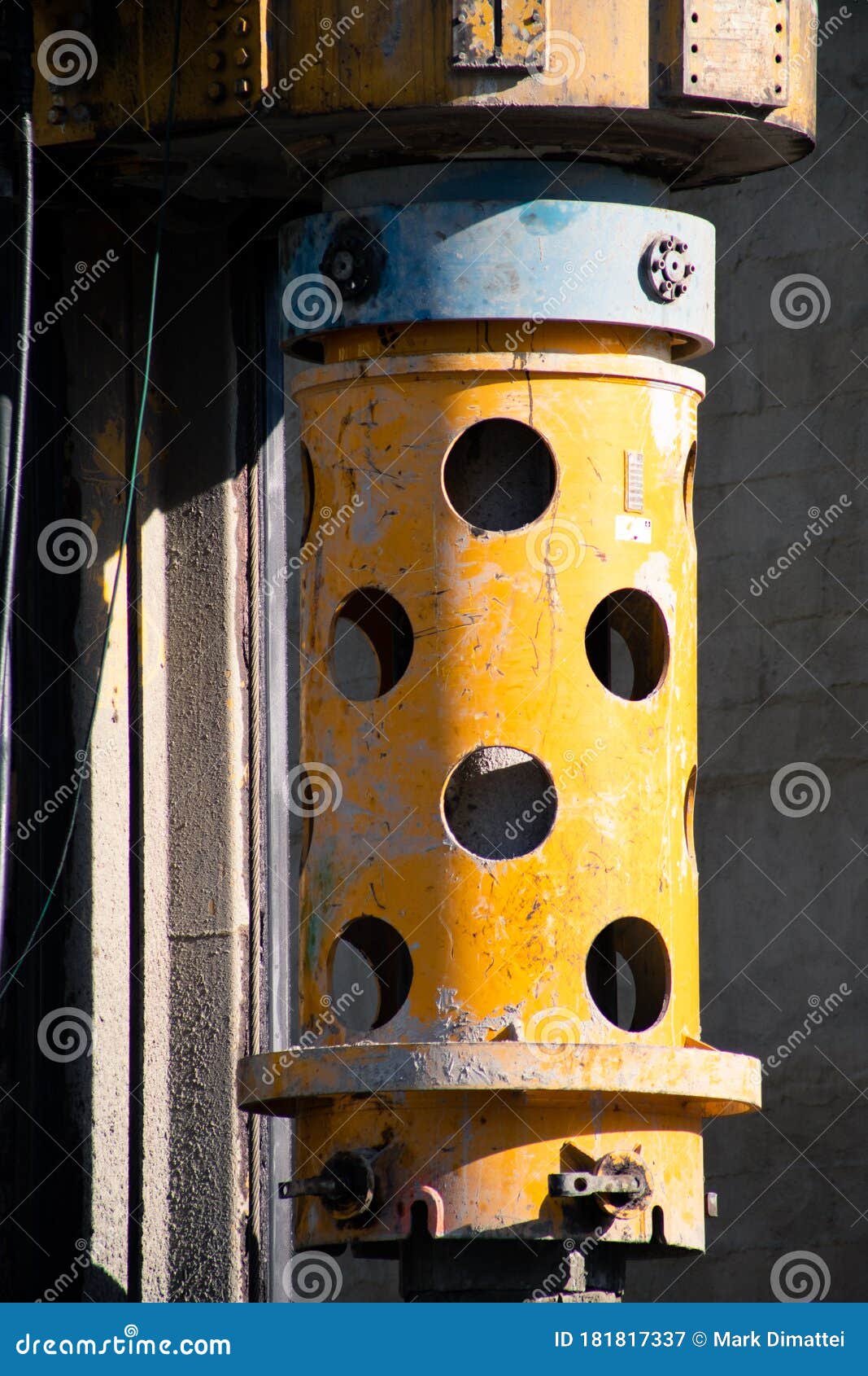 yellow construction site pillar and machine drill close up macro