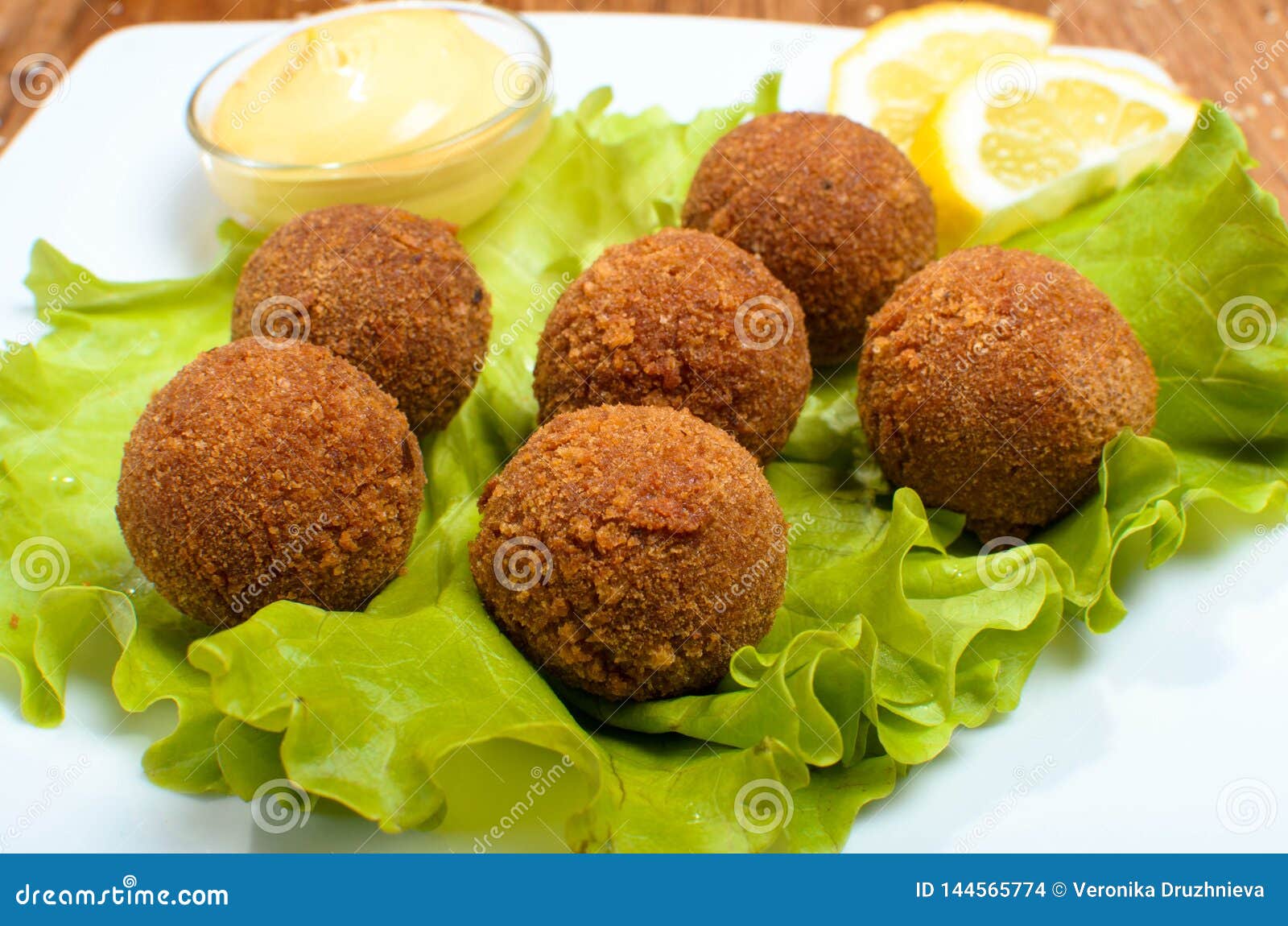 Deep Fried Cheese Balls on the with Dish with Salad. Tasty Dinner Stock