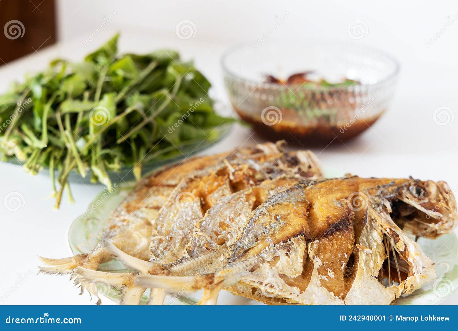 Deep Fried Fishes on Plate with Vegetable and Dipping Sauce on White
