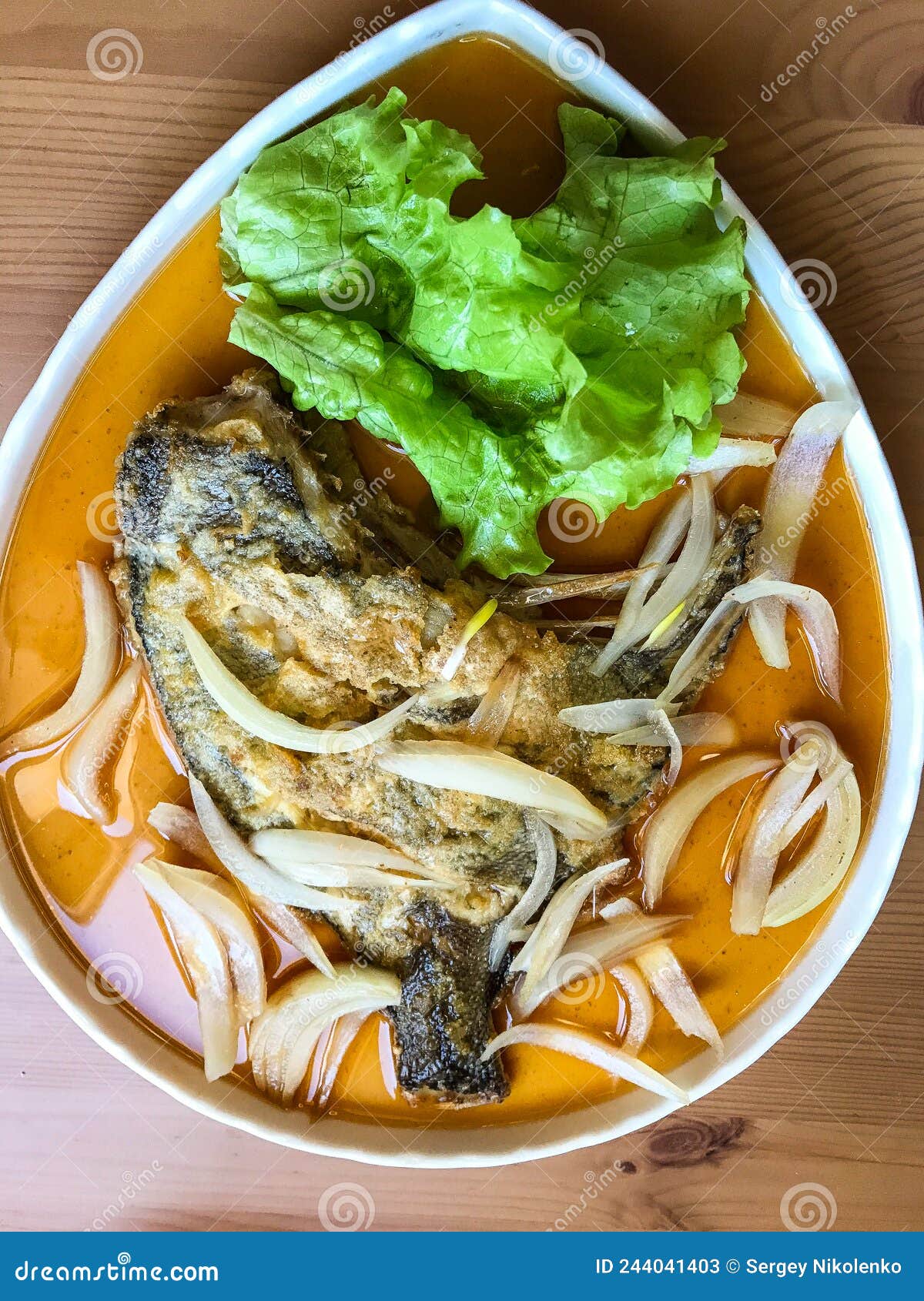 Deepfried Flounder with Onions and Vegetables in Asian Sauce on a