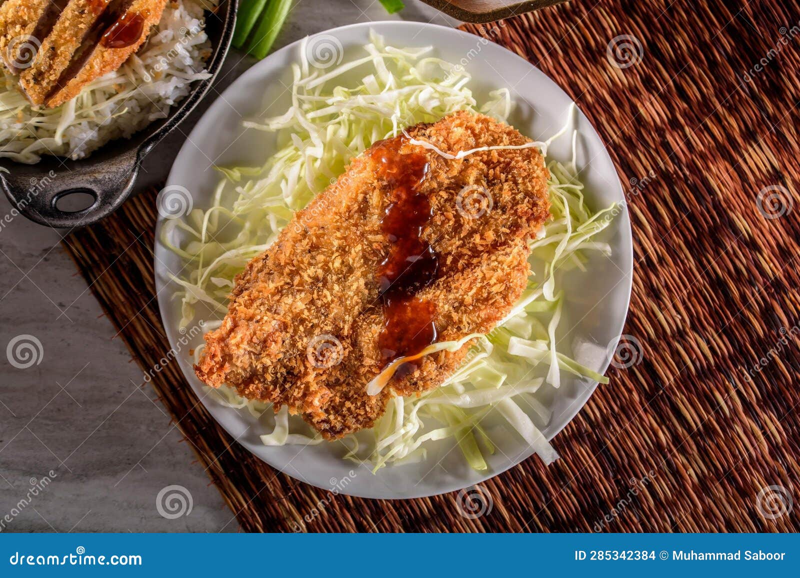 DeepFried Orange Chicken Served on a Bed of Steamed White Rice