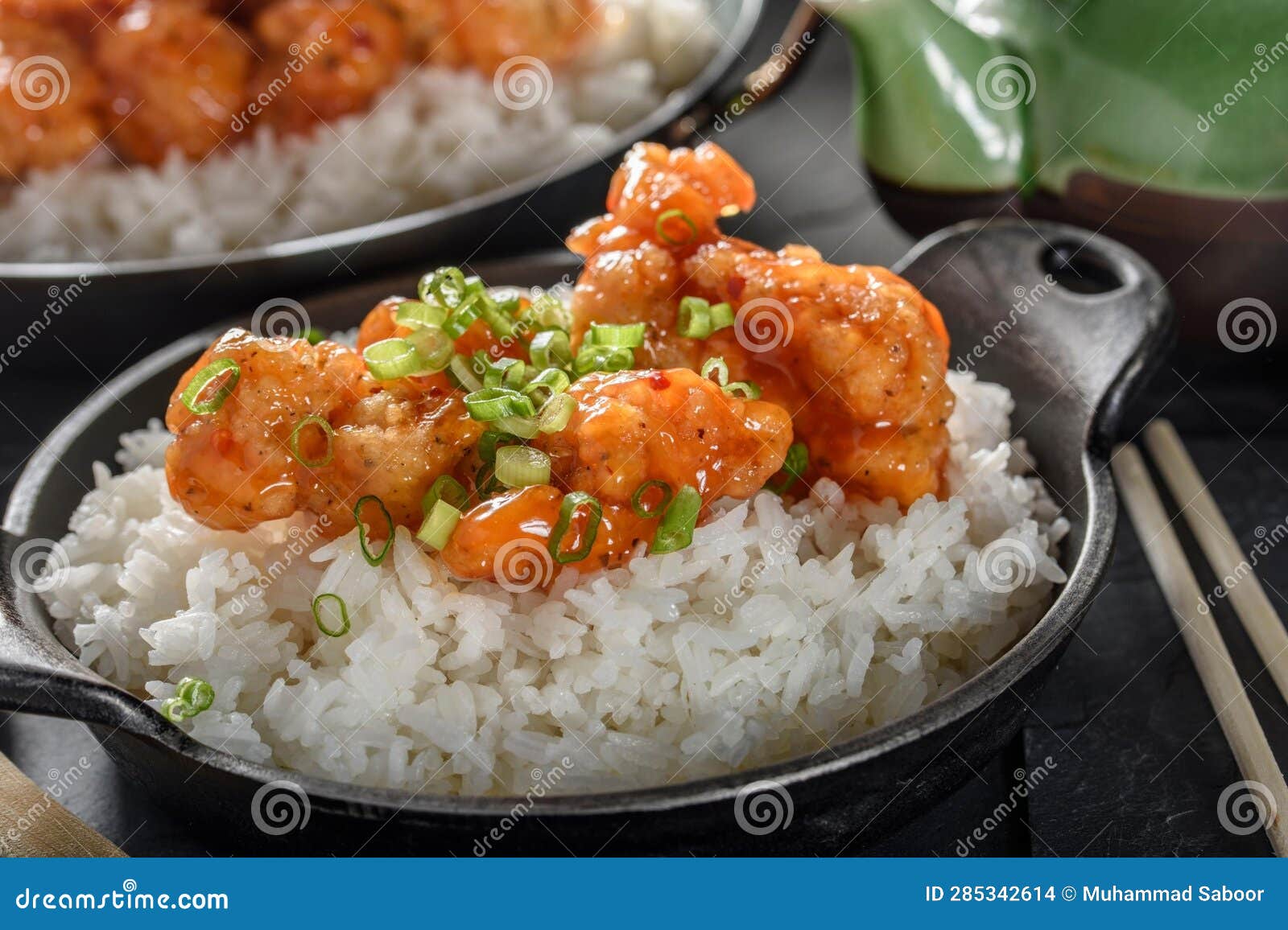 DeepFried Orange Chicken Served on a Bed of Steamed White Rice