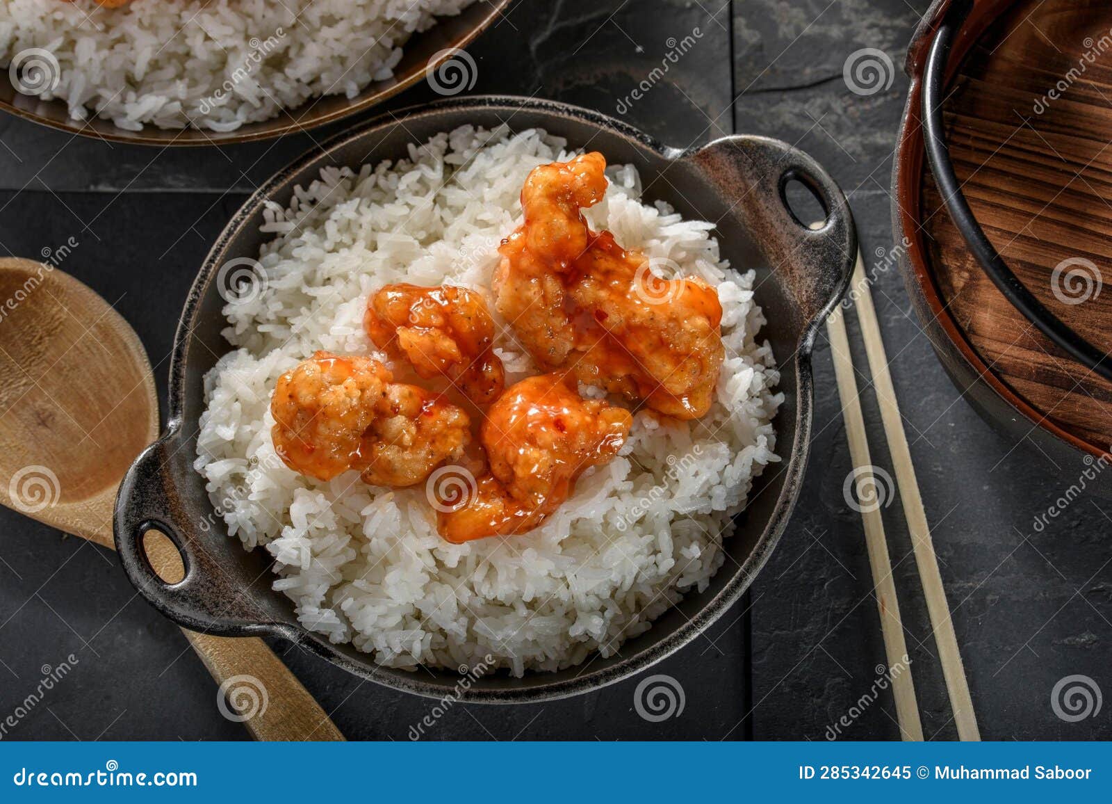 DeepFried Orange Chicken Served on a Bed of Steamed White Rice