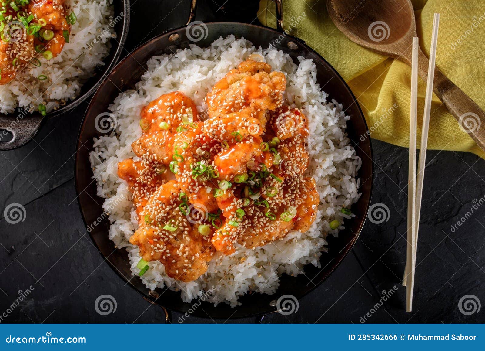 DeepFried Orange Chicken Served on a Bed of Steamed White Rice
