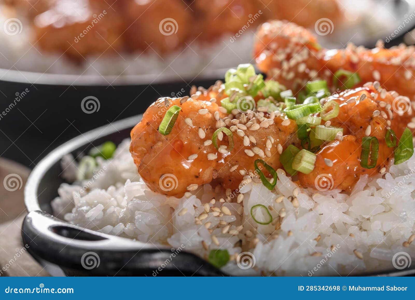 DeepFried Orange Chicken Served on a Bed of Steamed White Rice