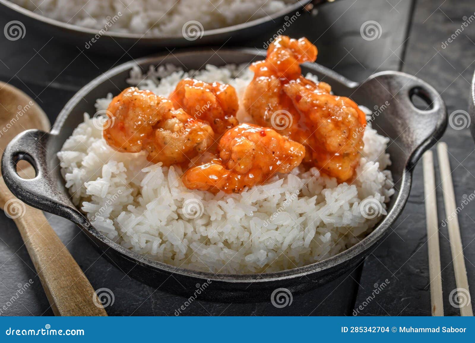 DeepFried Orange Chicken Served on a Bed of Steamed White Rice