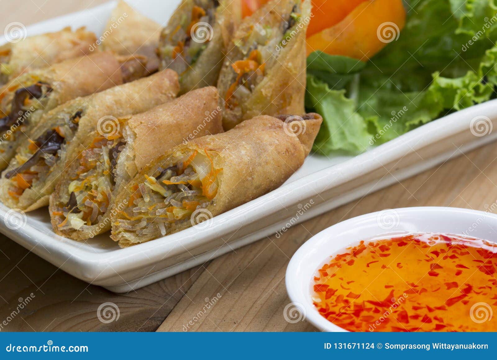 deep fried spring rolls, por pieer tod or fried spring rolls thai spring roll on white dish on wooden table,thai and chinese