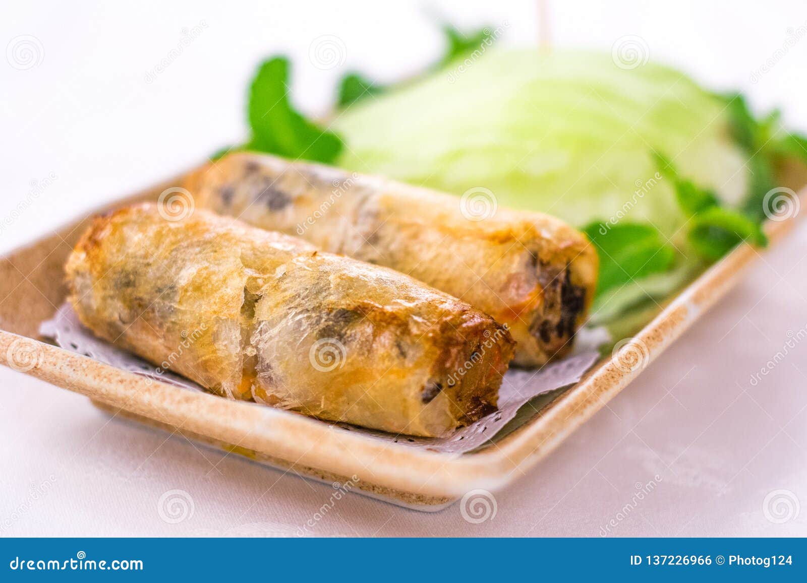 Deep Fried Vietnamese Spring Rolls Wrapped by Fresh Lettuce Stock Photo