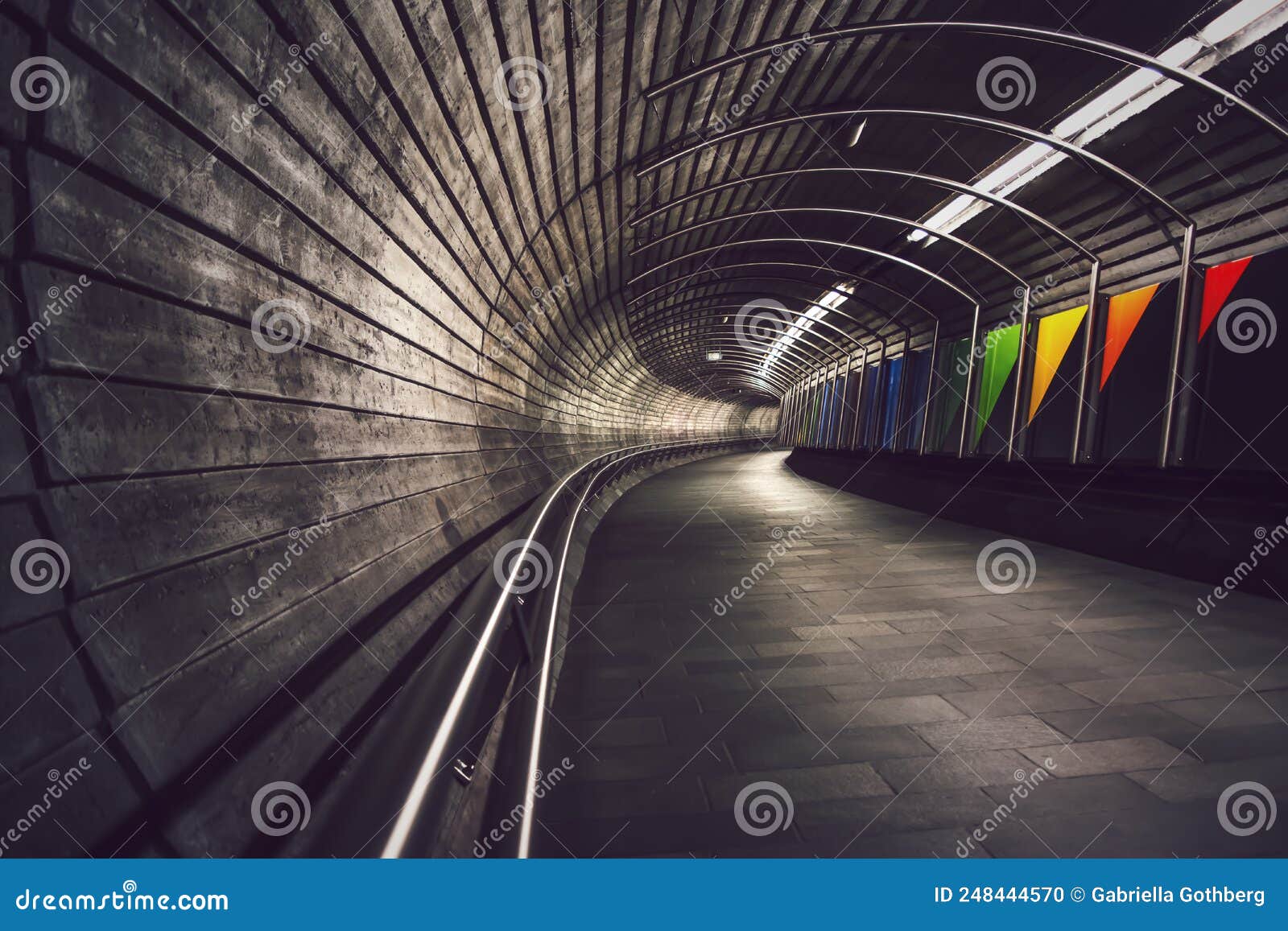 deep perspective into dark, winding underground tunnel