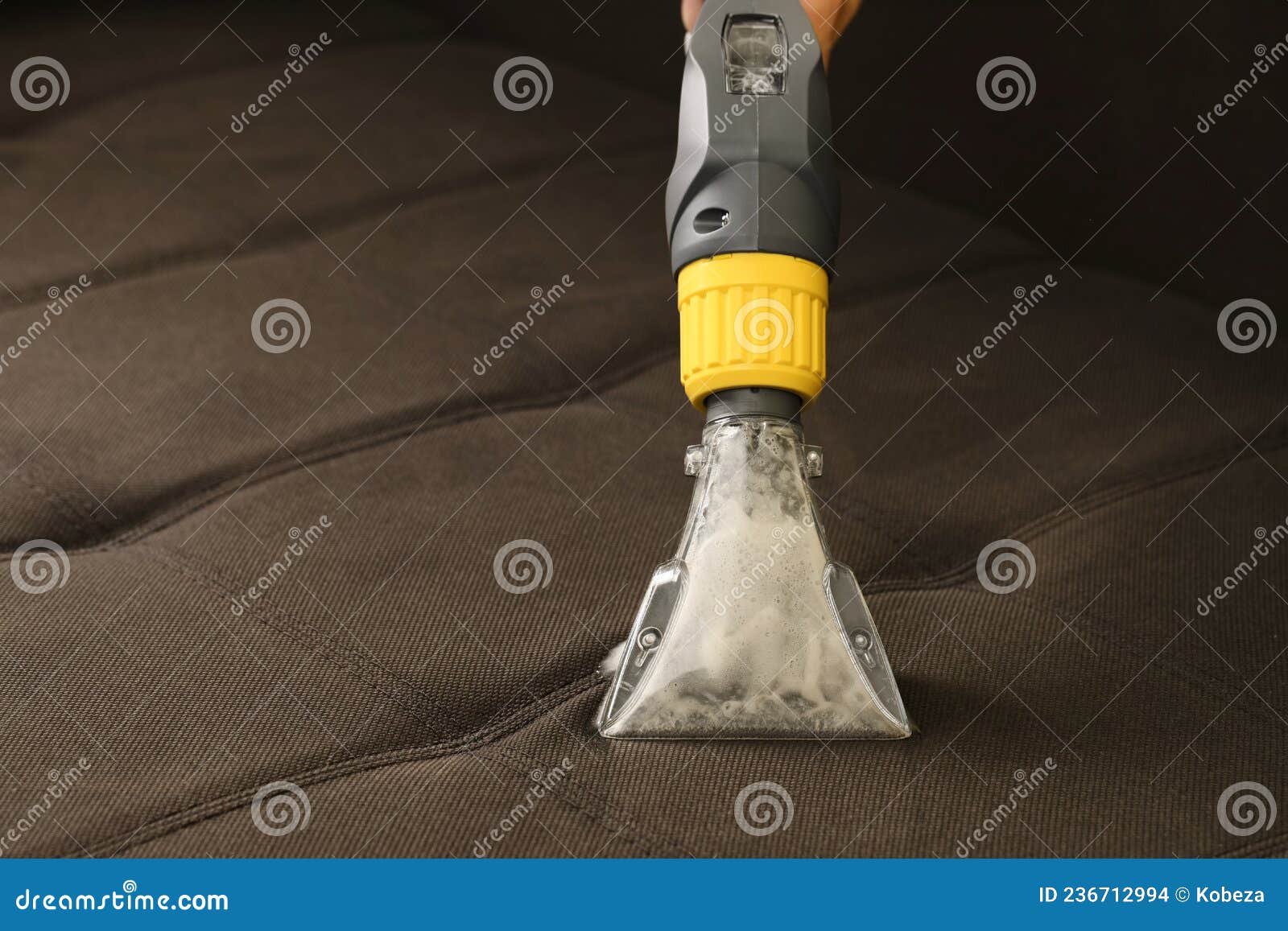Deep Professional Cleaning of Sofa with Vaccum Cleaner Stock Photo