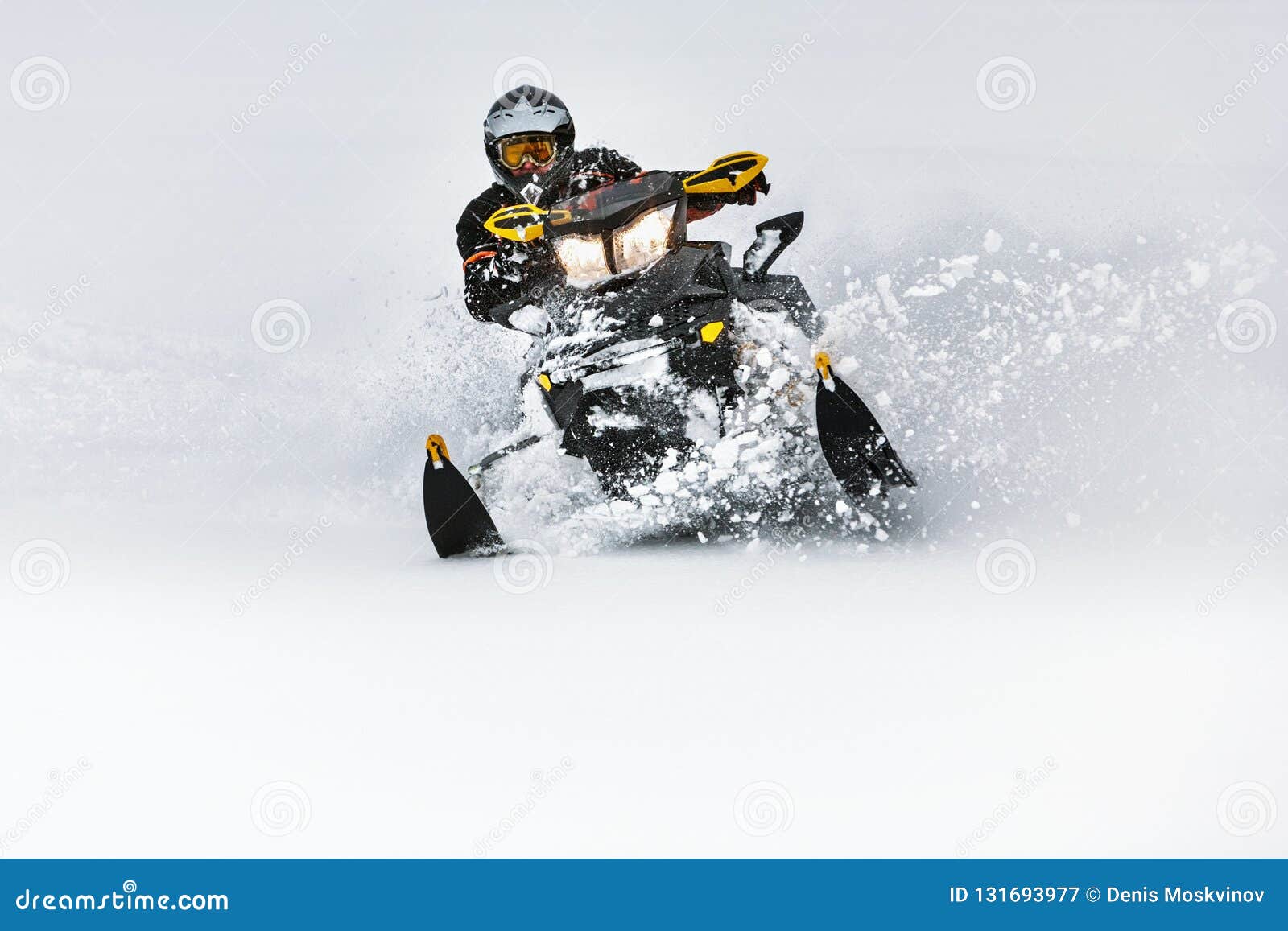 in deep snowdrift snowmobile rider make fast turn. riding with fun in deep snow powder during backcountry tour. extreme sport