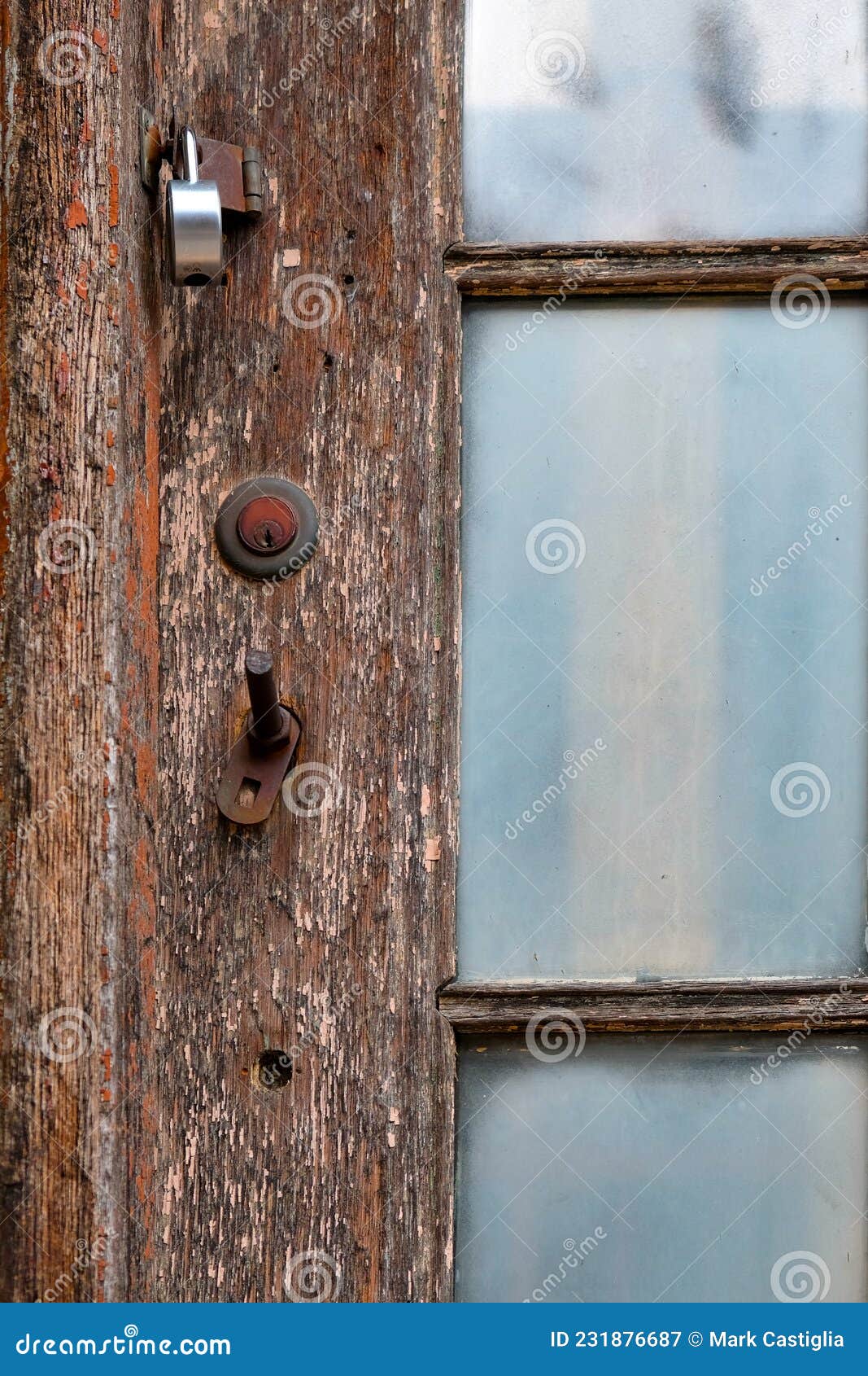 Worn Wooden Door with Rusty Keyhole and Glazed Window Panes Stock Image