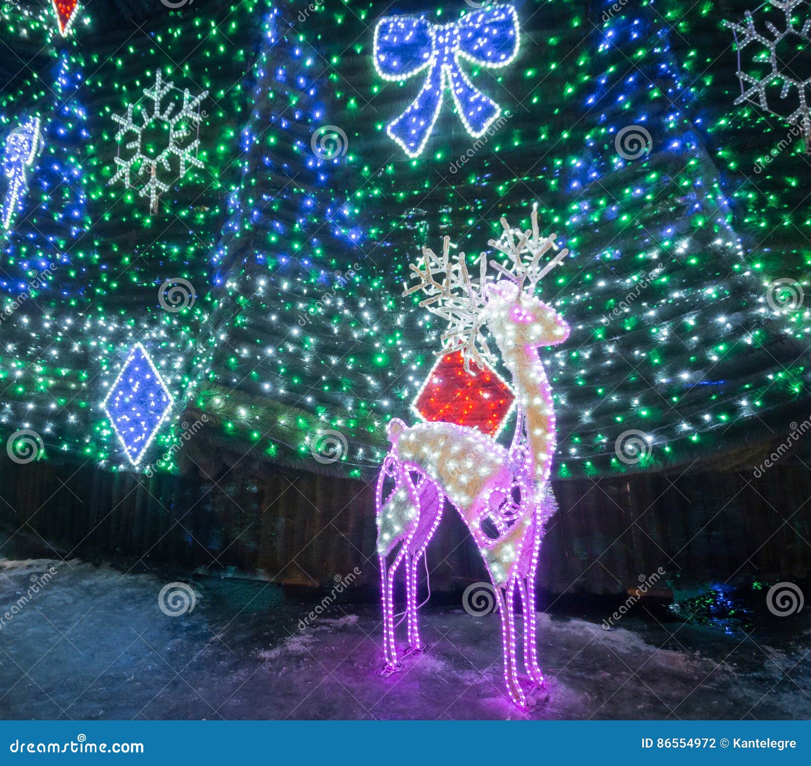 Deer with Bright Lights and Decorated Fir. Editorial Photography