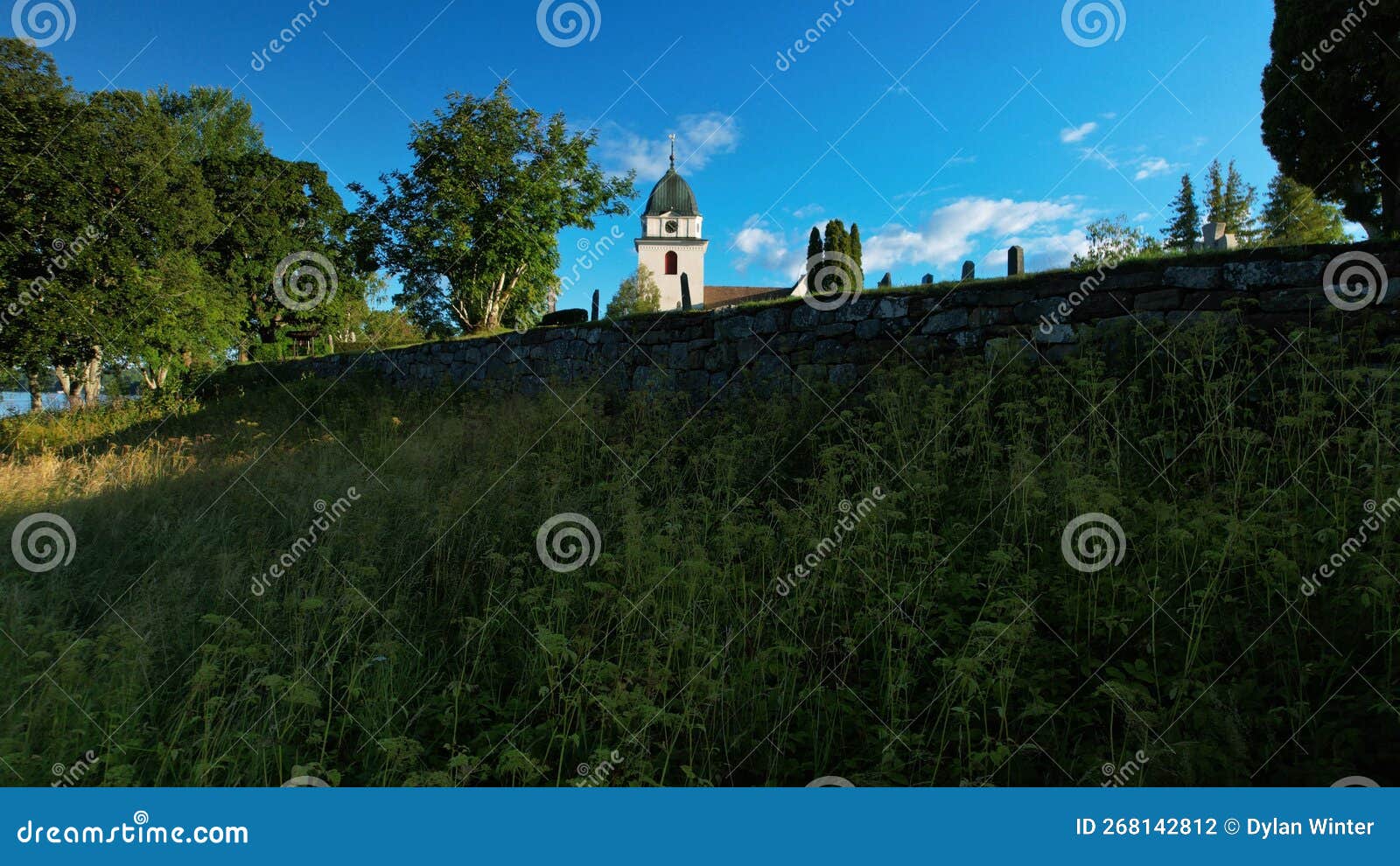 church bell tower protrudes above the stone wall in the town rattvik in sweden