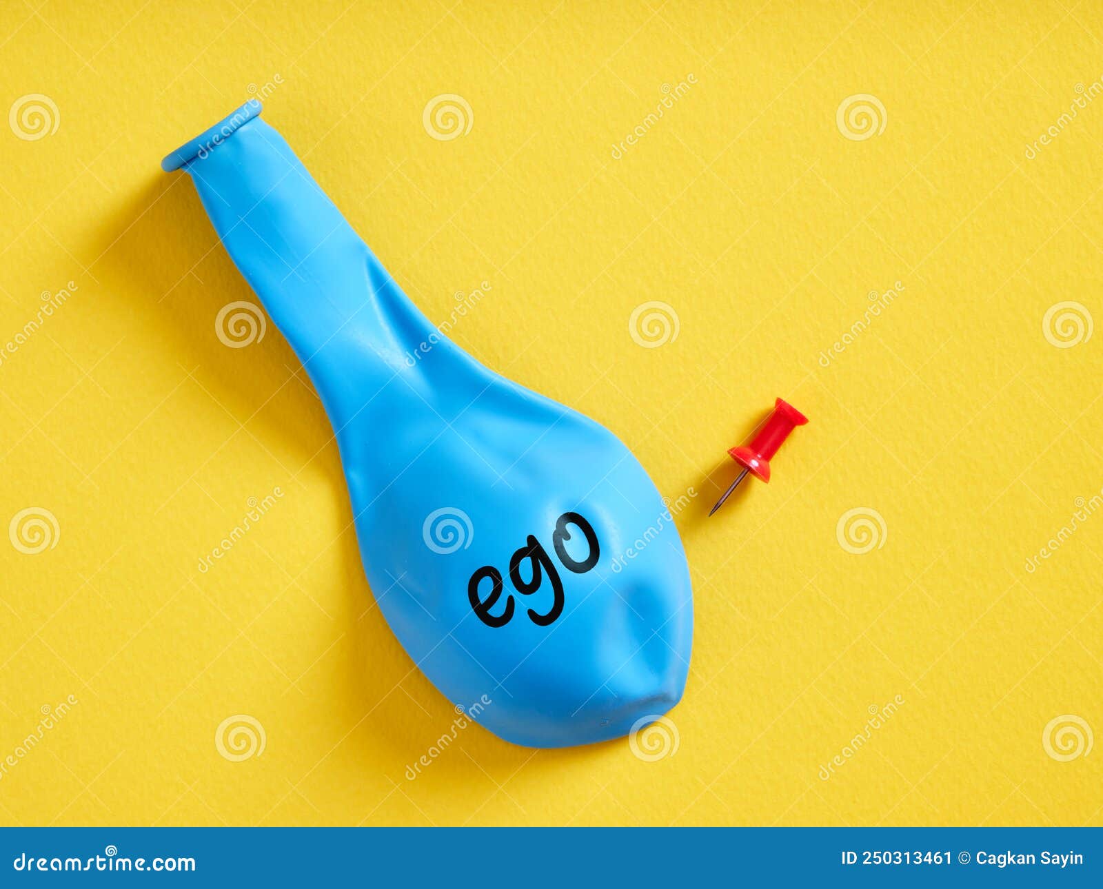 Deflated Blue Balloon with the Word Ego and a Pin. Selfishness or