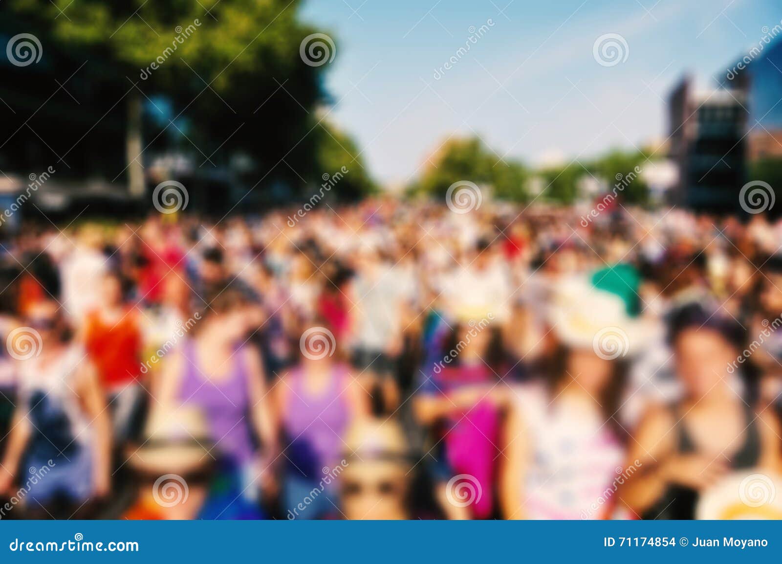 defocused background of people partying or marching outdoors
