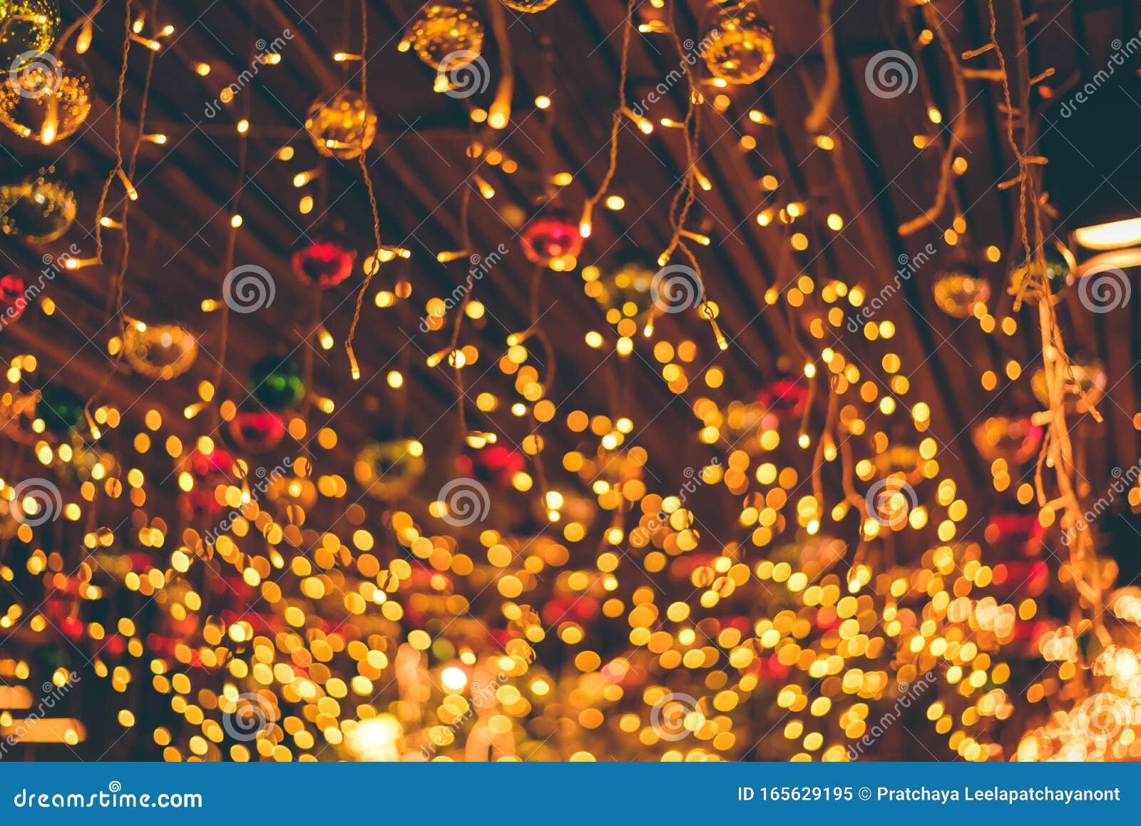 Defocused Ligths Of Christmas Ornaments Hanging From Ceiling