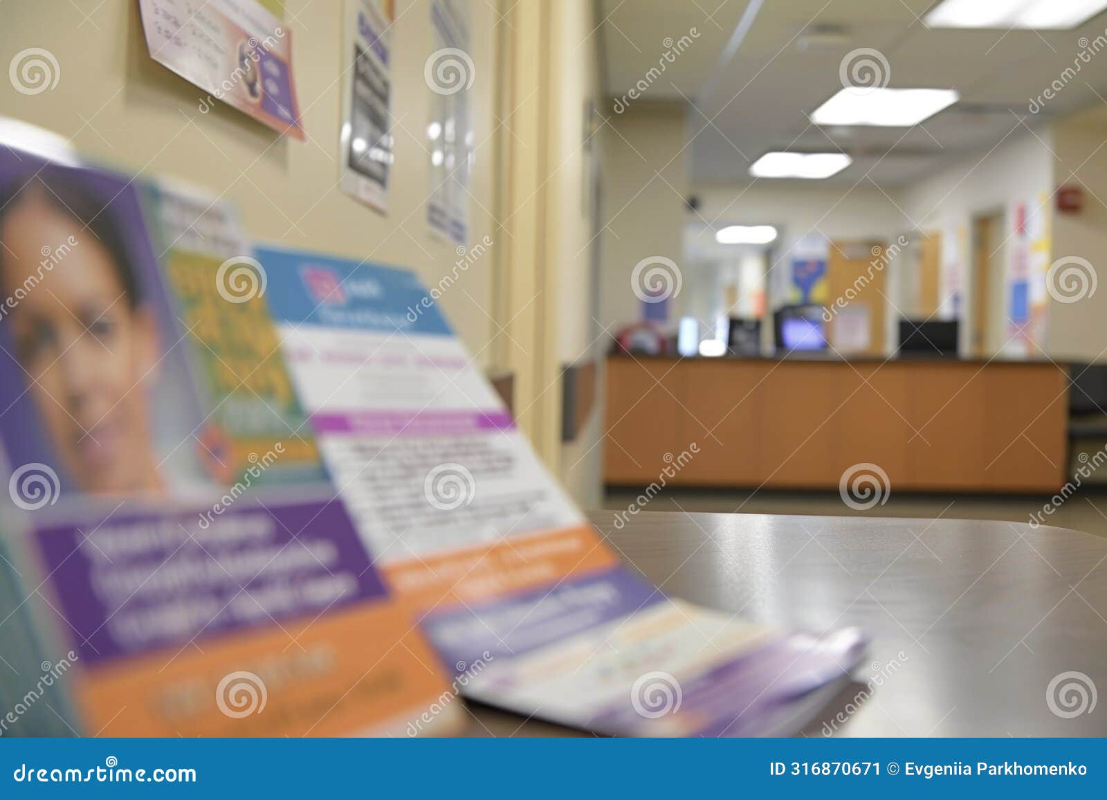 defocused view of reception desk in modern office with informational pamphlets