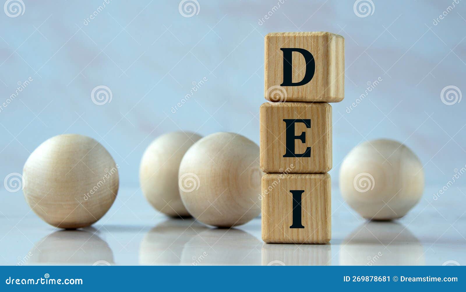 DEI - Acronym on Wooden Cubes on the Background of Light Balls