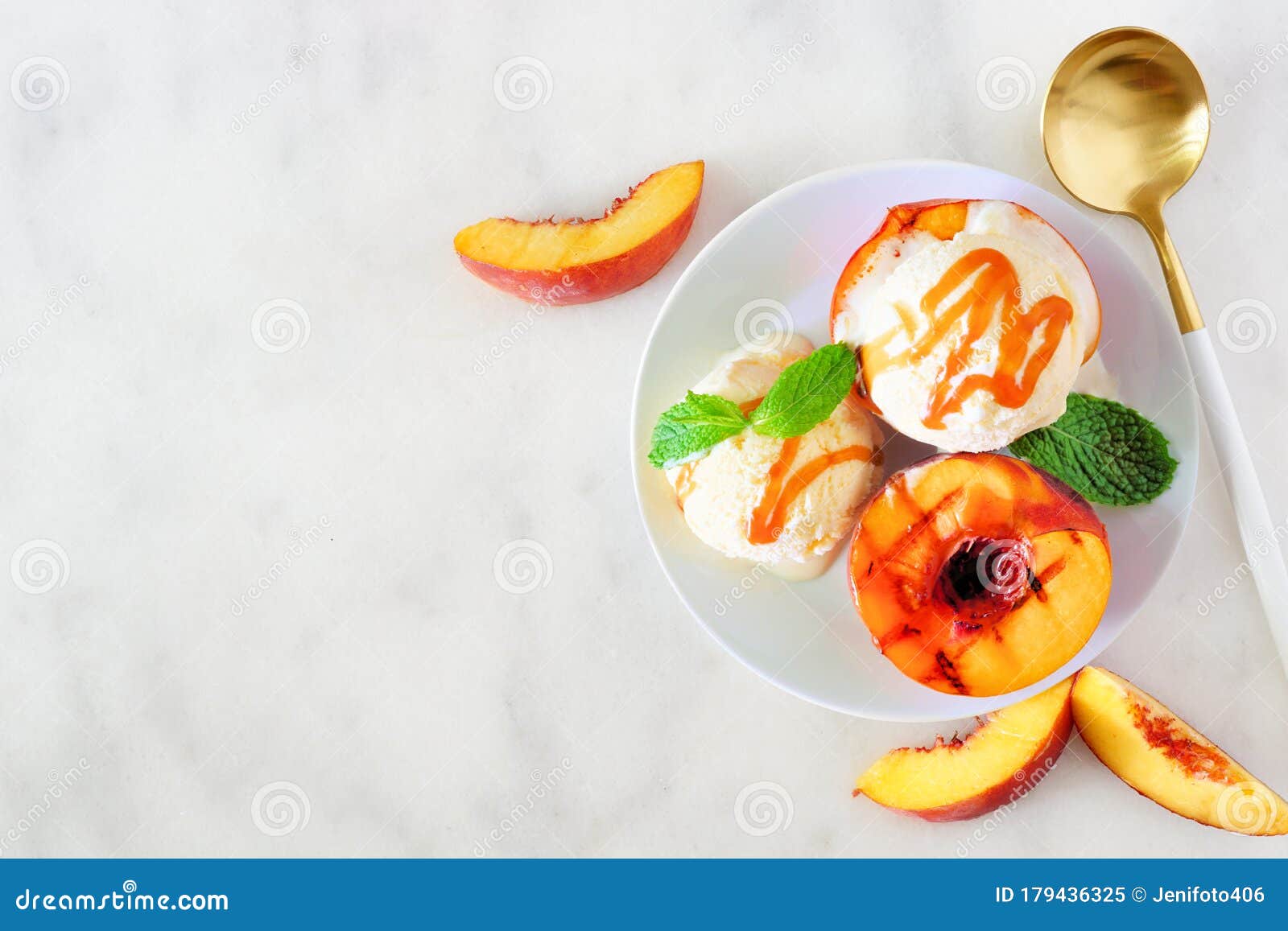 delicios grilled peaches with vanilla ice cream, top view table scene on a white marble background