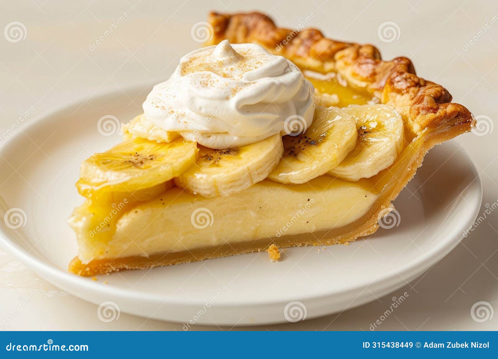 delicious banana cream pie with whipped topping on a white plate