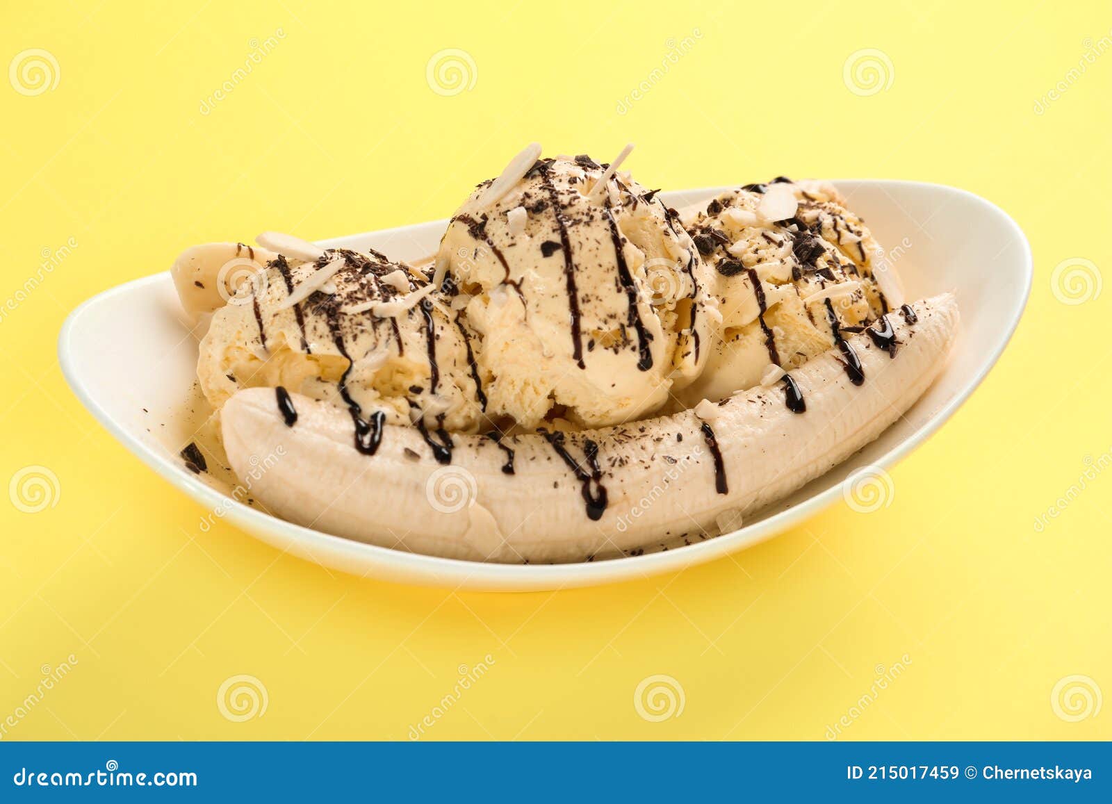 Delicious Banana Split Ice Cream with Toppings on Yellow Background