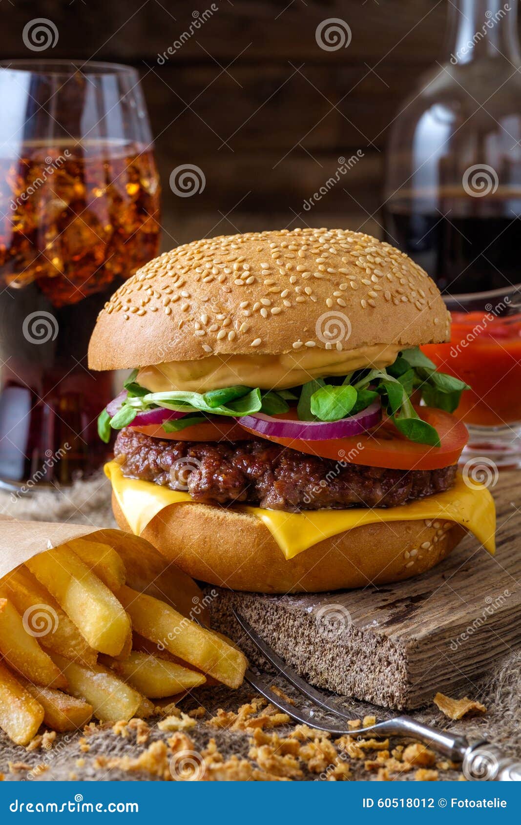 Delicious Burger with Chips and Soda on Wooden Table. Stock Photo